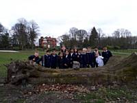 Meanwood students around the fallen tree with 'Tree Stomper' the Troll - which will be part of a new park feature.